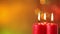 Closeup of three burning christmas candles
