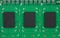 Closeup three chips with space for text on green PCB