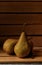 Closeup of Three fresh picked Bosc Pears in a wooden packing crate