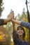 Closeup of three women joining hands high up in the air