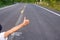 closeup thumb up of woman on the road in the country