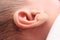 Closeup Of Tiny cute New born Baby`s Ear with hair