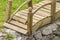 Closeup of tiny wooden bridge. Garden decoration