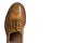 Closeup of Tip Medalion of One Brogue Derby Shoe of Calf Leather with Rubber Sole Over Pure White Background