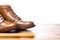 Closeup of Tips of Pair of Tanned Brogues Boots. Isolated Over White Background