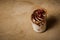 closeup tiramisu dessert with pomegranate grains in plastic cup