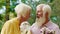 Closeup to the camera at the cafe romantic old couple lovely looking drinking some lemonade in the middle of the park