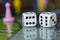 Closeup to a double six old white dices with pink pawn over board game