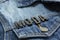 Closeup to a fashion word in spanish `MODA` lettering black word over a gradient Blue jean jacket