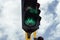 Closeup to a green traffic light near to a vehicular traffic light in a bike path crossroad