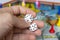 Closeup to a Hand holding a double five pair old white dices over a board game