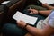 Closeup to hand of student holding pen and taking exam in classroom with stress for education test