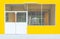 Closeup to Metal Entrance Door of Concrete Yellow Factory Warehouse