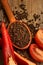 Closeup Tomaten, Red hot chili peppers and black pepper whole in wooden spoon on old wooden background