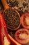 Closeup Tomaten, Red hot chili peppers and black pepper whole in wooden spoon on old wooden background