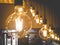 Closeup toned image of lots of decorative incandescent lamps in modern interior