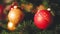 Closeup toned video of red and golden baubles on CHristmas tree with glowing and blinking colorful lights