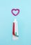 Closeup of a toothpaste and toothpaste heart on blurred blue background. Dentistry conceptual photo