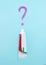 Closeup of a toothpaste and toothpaste question on blurred blue background. Dentistry conceptual photo. Concept of oral hygiene in
