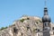 Closeup of top of Citadelle and spire of Notre Dame Church in Dinant, Belgium