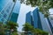 Closeup of top modern high-rise building in Dao Tan street, Hanoi, Vietnam. Mirroring of concrete skyscrapers on blue sky in shiny