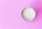 Closeup top view milk in white ceramic cup on pink background, s