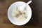 Closeup top view mush or boiled rice in white bowl, morning breakfast