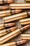 Closeup top view of rifle full metal jacket bullets on wooden background