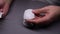 Closeup top view of unrecognizable man comparing different replacement panels for new wireless mouse sitting at table in