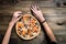 CLOSEUP Top view VERY HOT SLICED Italian Pizza with hand take a slice on wooden table with mushrooms, tomato, olives and
