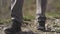 Closeup tourist man legs hiking in nature against mountain background. Sports shoe closeup, exercise outdoors.