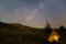 Closeup touristic tent among sandy prairie under starry sky with milky way