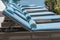 Closeup of towels on lounge chairs near a luxury swimming pool at a tropical resort spa in island Zanzibar, Tanzania, East Africa