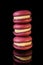 closeup tower of three berry macaroons with yellow filling