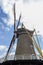 Closeup of tower, yellow start bars and blades at Korenbloem windmill