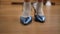 Closeup tracking shot of little female feet putting on high-heels walking on parquet floor indoors. Close-up