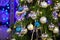 Closeup of traditional artificial Christmas tree with various ball ornament