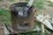 Closeup of traditional clay stove with ash and pile of firewood.