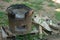 Closeup of traditional clay stove with ash and pile of firewood.