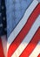 Closeup of translucent flag with Stars and Stripes visible hanging diagonally