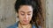 Closeup of a trendy, edgy and flirty woman with braided hair or dreadlocks, smiling with and happy expression. Headshot