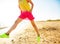 Closeup on trendy woman on seashore in evening jumping