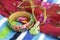 Closeup of tropical bracelet, necklace and swimwear wrap on beach towel, vibrant colors, travel concept