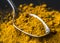 Closeup of tumeric powder spice on a spoon