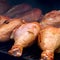 Closeup turkey legs on barbecue grill with smoke, bbq meat - ready grid over charcoal
