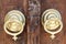 Closeup of two antique copper ornate door knockers over an aged wooden ornate door