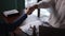 Closeup of two businesspeople shaking hands and sitting at table with suit in modern office spbas.