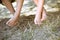 Closeup of two children legs barefoot on sunny