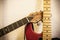 Closeup of two guitar necks over wall background