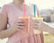 Closeup of Two hands holding healthy fruit smoothie drinks